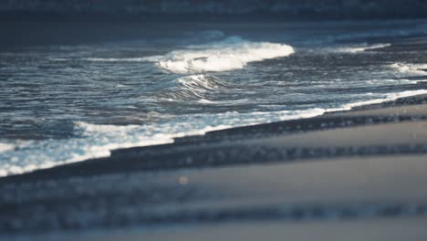 the gentle waves break around the sandy shallows on the ersfjord beach