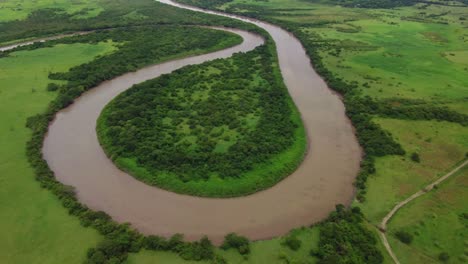 drone shot aerial view winding river, tropical rain forest, natural wilderness