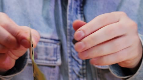 a closeup detail of an individual holding a 100 euro banknote, showcasing its vibrant and detailed design