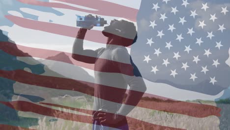 Animation-of-american-flag-over-african-american-man-drinking-water-in-mountains