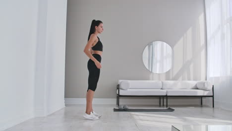 Beautiful-Fit-Girl-Doing-Home-Workout-Performing-Lateral-Lunges-In-A-Sitting-Room