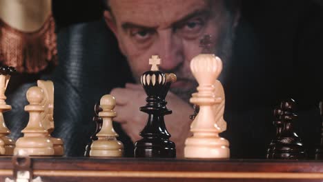 Concentrated-Man-Playing-Chess,-He-Is-Thinking-And-Looking-At-The-Chessboard---close-up