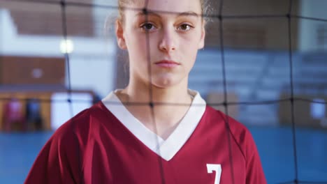 female player holding volleyball in the court 4k