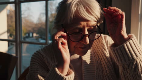 elderly woman contemplating at the window