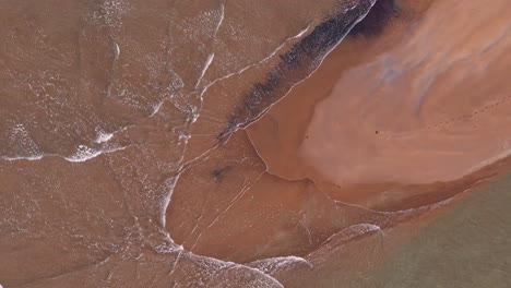 crystal-clear-water-of-philippine-ocean,-waves-gently-splashing-on-one-of-the-sandbars-in-Surigao,-aerial-drone-shot