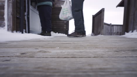 closed-door-with-strong-wind-in-cold-winter-cabin-wooden-low-angle-foot-view