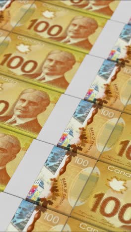 vertical video of 100 canadian dollar banknotes printing by a money press