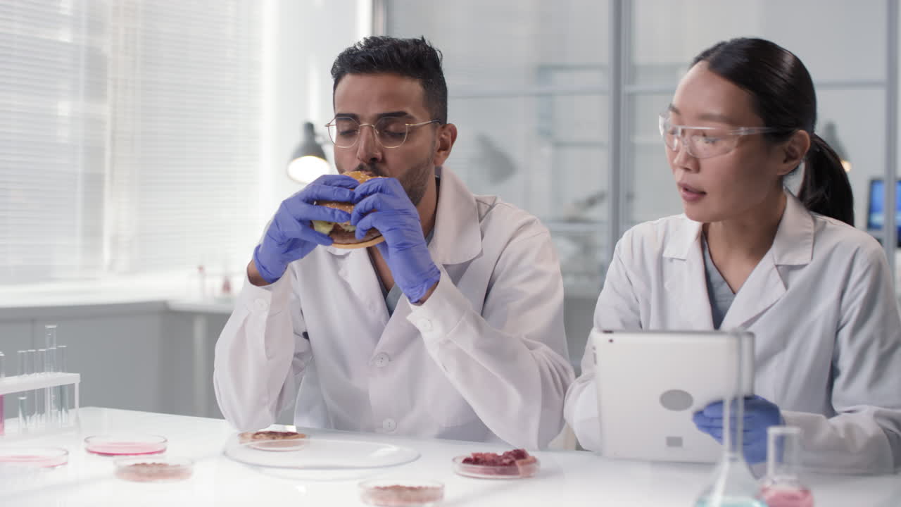 Scientists eating a burger in a laboratory setting | Premium Stock ...
