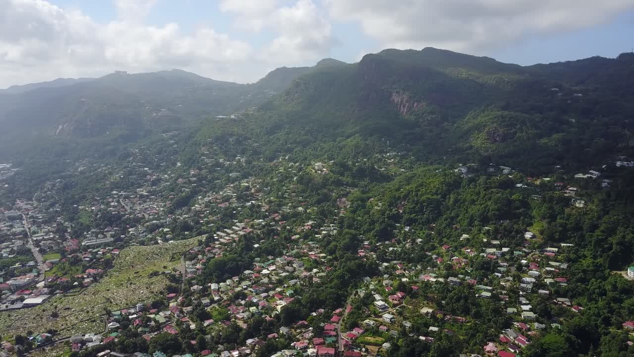 Seychelles beauvallon mountain. Palmtree sky and Native natural forest sky town