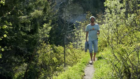 A-person-is-walking-barefoot-on-a-mountain-trail