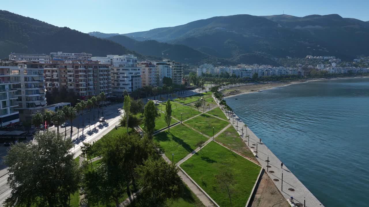 Aerial: Vlore cityscape and beach during the day with the Adriatic Sea and mountains in Vlore County, Albania, parallax drone shot