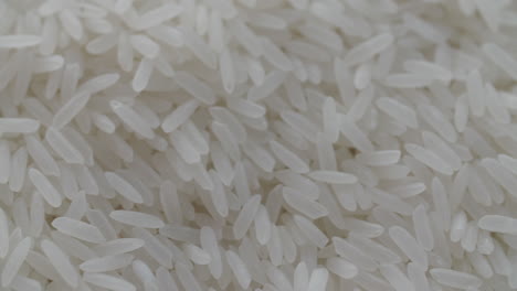 macro shot of white rice grains being shoveled in slow motion