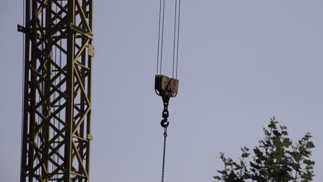 Industrial-crane-hook-swinging-in-the-wind