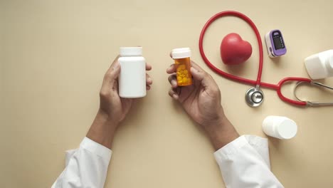 doctor holding medical bottles and stethoscope