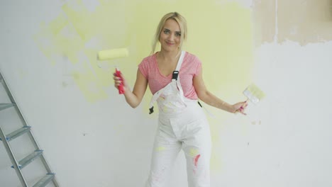 relaxed woman dancing with paint roller