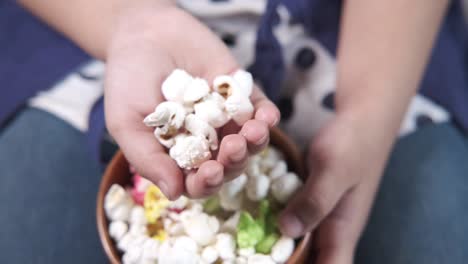 child eating popcorn