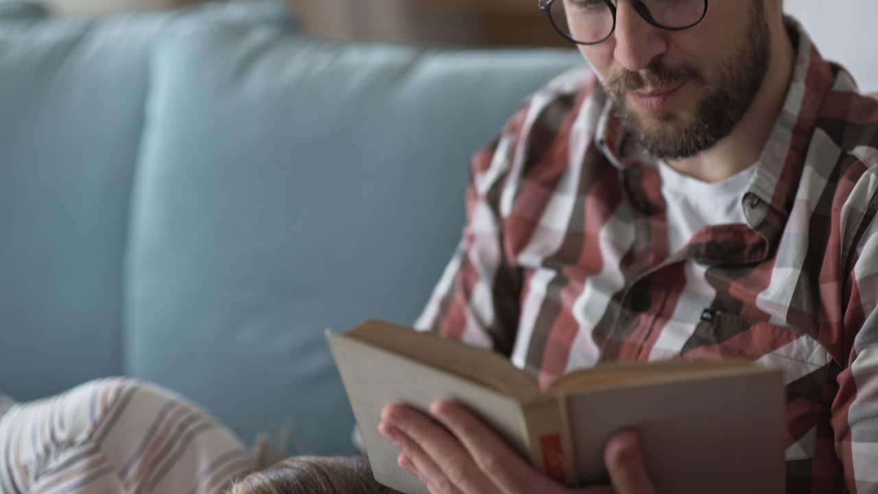 Couple reading a book on a couch