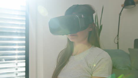 girl having fun using a vr headset, watching and catching virtual objects