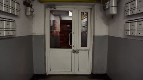 Going out to the door from old block apartments from Romania