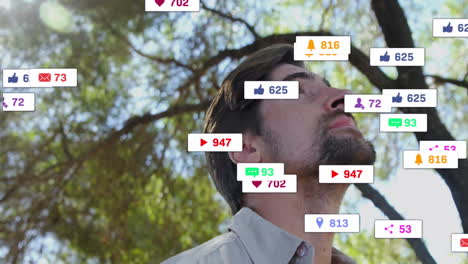 man tilting head upward outdoors, with floating social media marketing icons tracking engagement
