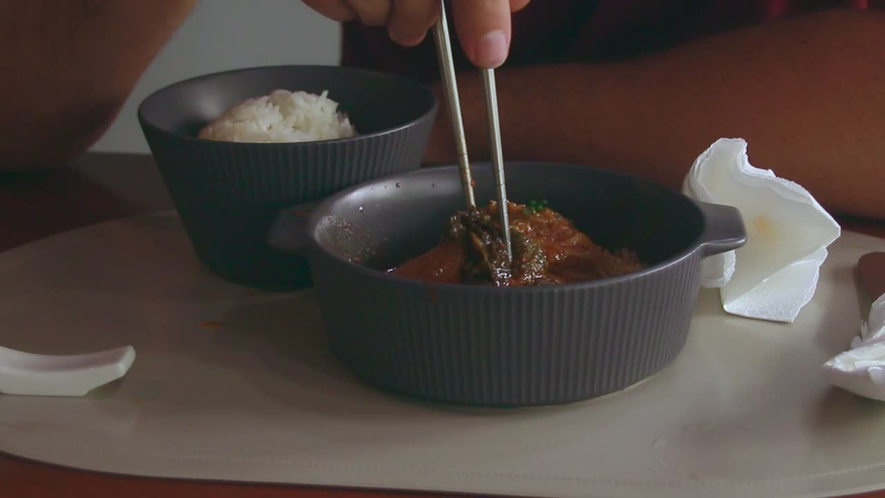 Candid authentic scene, using napkins while eating kimchi jjim or braised pork in kimchi stew, local Korean dish