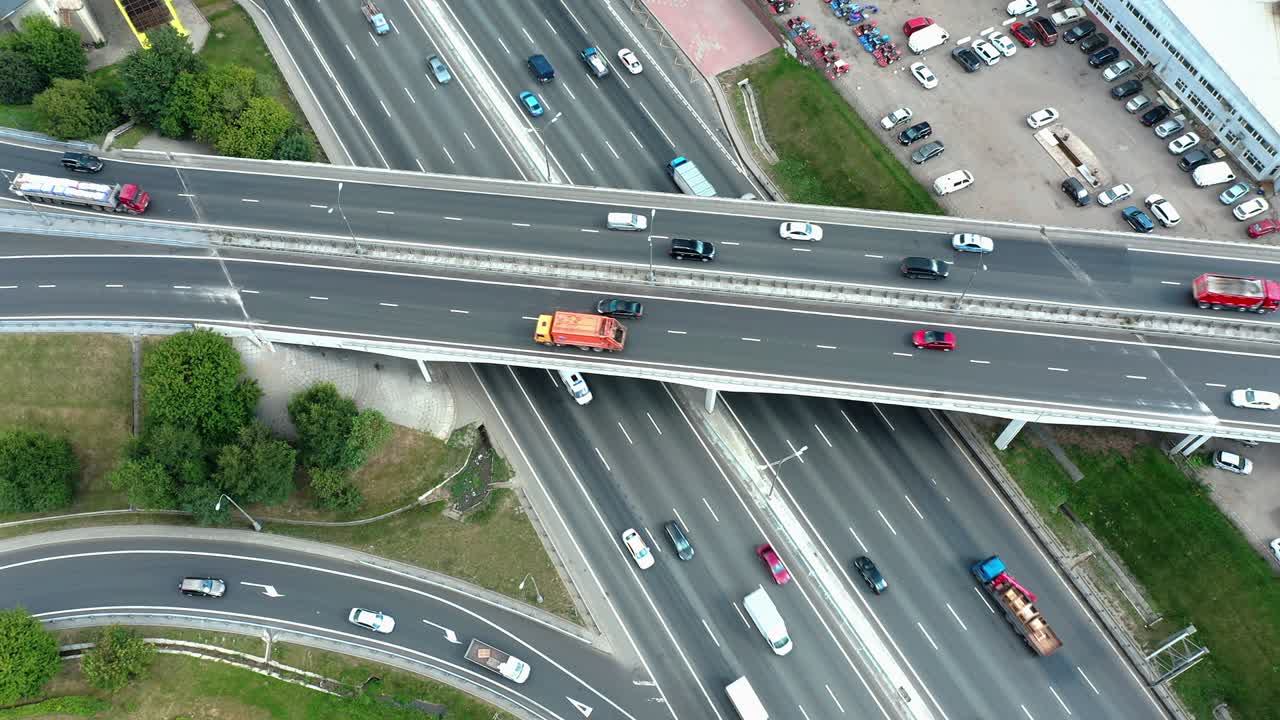 Aerial view of highway junction with traffic, static camera locked down
