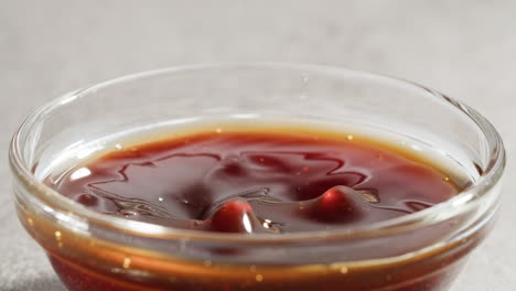 hand dipping french fries in sweet and sour sauce