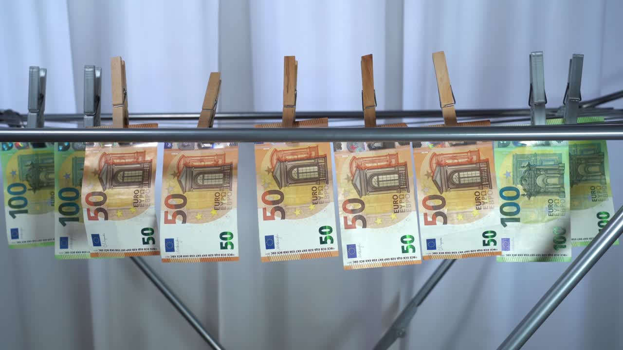 money hanging to dry with clothespin - Euro money banknotes after  washing machine - illegal cash 50, 100 €  and mafia money laundering - increase in the cost of living, energy and gas