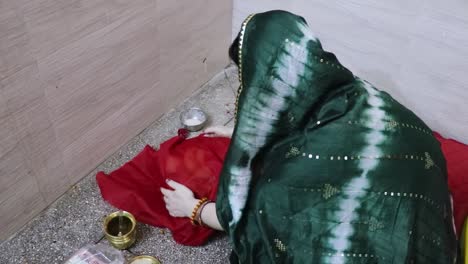 indian women doing holy rituals at home for children's wellbeing from different angle on the occasion of jitiya vrat or nirjala vrat in india