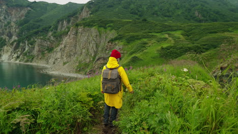 woman hiking along a rocky coastline