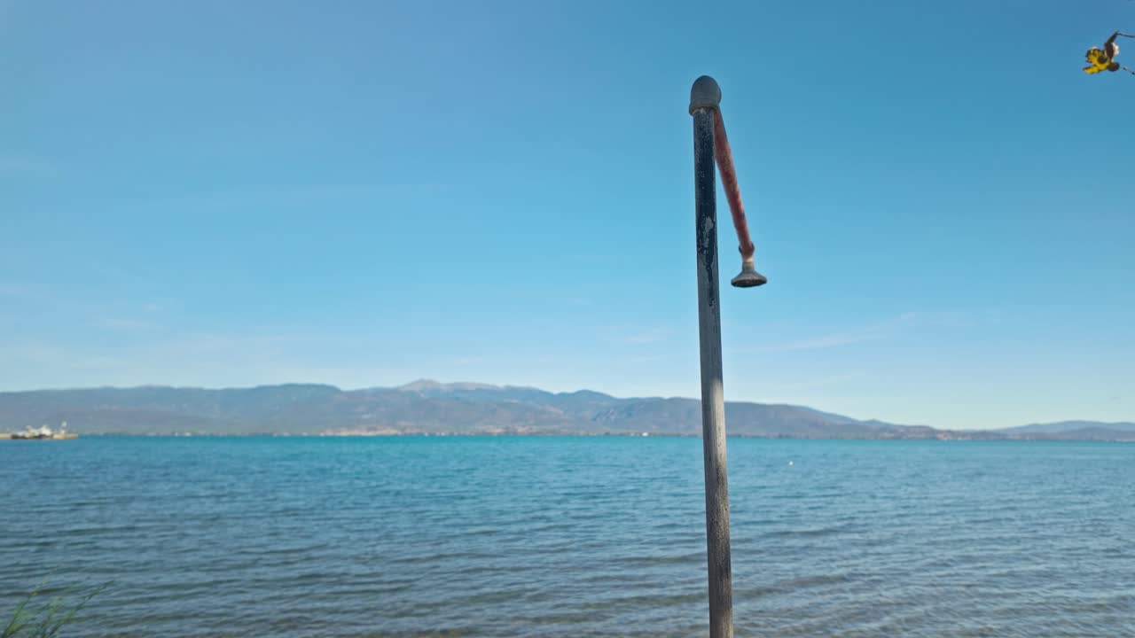 Old outdoor beach shower head sprinkler on Mediterranean seaside