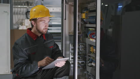 engineer checking electric panel at factory