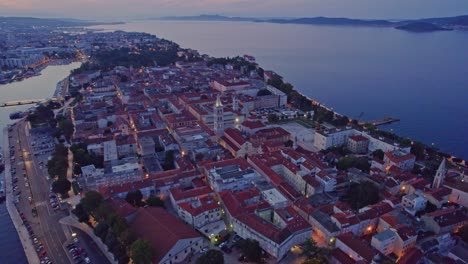 Picturesque-medieval-town-Zadar-early-morning-blue-hour-scenery,-aerial