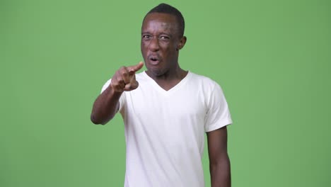 young angry african man pointing at camera