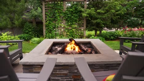 close-up-push-in-shot-of-a-propane-fire-pit-flame-on-a-patio-during-the-day