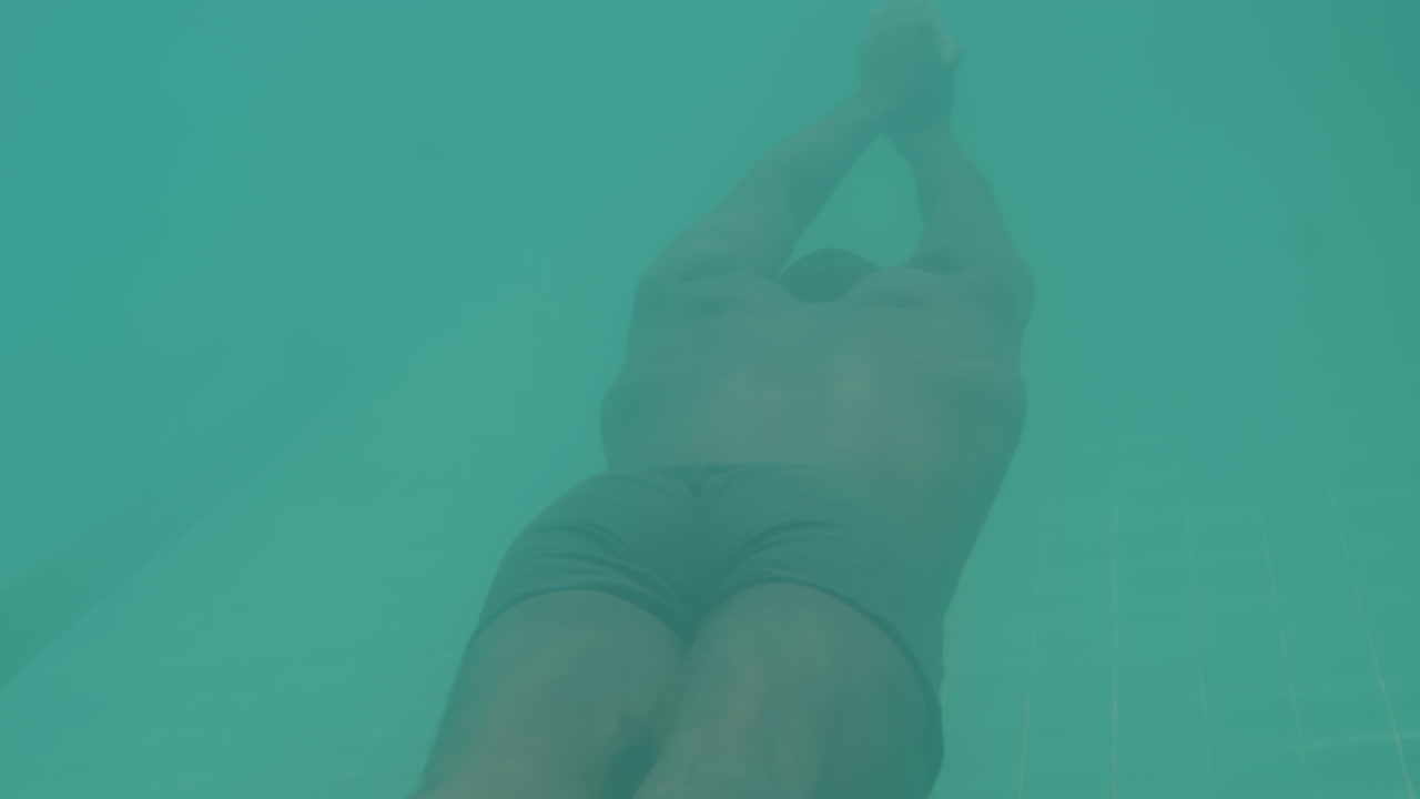 Underwater View of African American Man Swimming in Pool