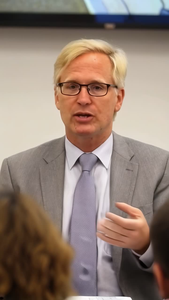An adult businessman giving a presentation in the office.
