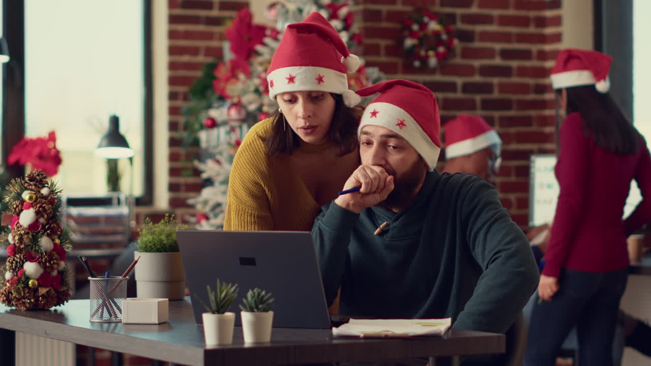 Team of people looking at data research on laptop
