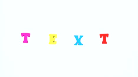 word "text" formed of wooden multicolored letters. colorful words loop.