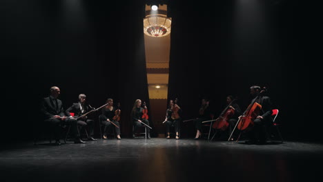 musical band of cello violin bassoon and flute playing on scene of opera house curtains opening