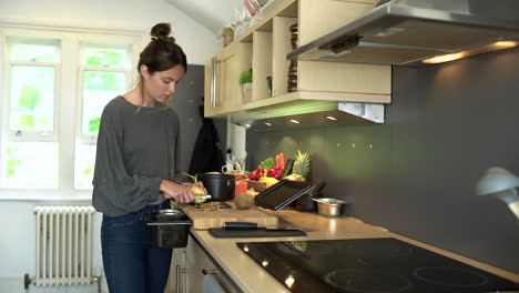 dolly in shot of young woman peeling a potato