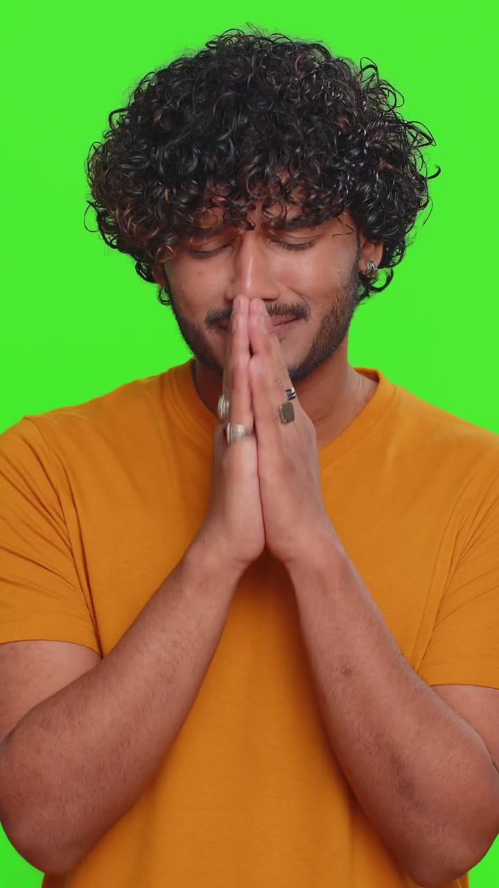 Indian handsome man praying looking upward making wish begging apology asking help forgive me