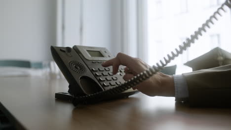 man using phone on desk