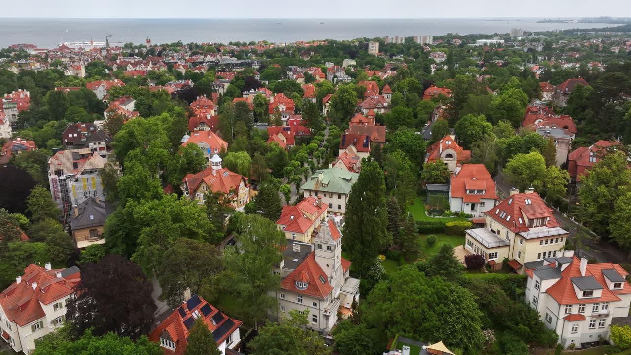 Aerial view rotating over the suburbs of Sopot city, sunny, summer day in Poland