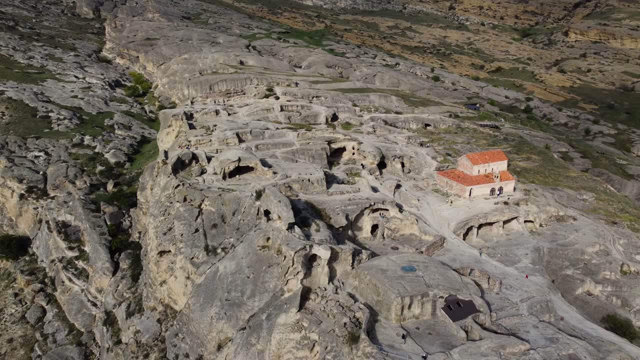 Top of Uplistsikhe cave dwellings carved in rock cliffs showing ancient city layout