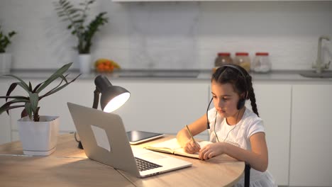 Kids-distance-learning.-Cute-little-girl-using-laptop-at-home.-Education,-online-study,-home-studying,-technology,-science,-future,-distance-learning,-homework,-schoolgirl-children-lifestyle-concept.