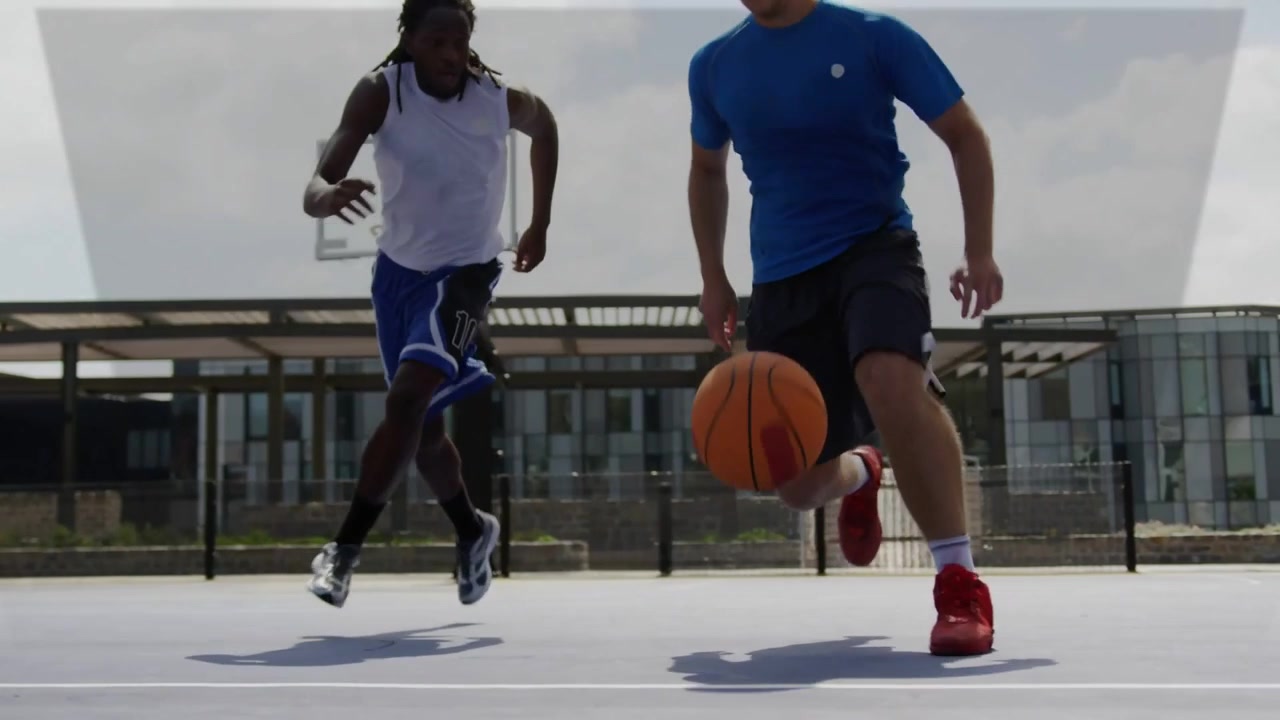Player dribbling into lens, initiating sports overlay pulsing red cyan markers for drive