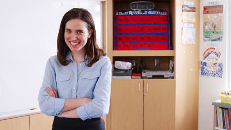 Female-elementary-school-teacher-standing-with-arms-crossed