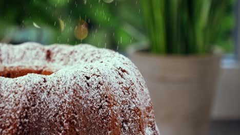 Statische-Nahaufnahme-Eines-Köstlichen-Gebackenen-Marmorkuchens,-Der-In-Der-Küche-In-Zeitlupe-Mit-Süßem-Puderzucker-Beträufelt-Wird,-Um-Ein-Köstliches-Dessert-Zu-Erhalten