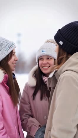 three young students talking and enjoying themselves on the university campus.